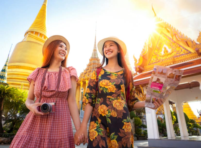 Two women exploring the Grand Palace complex in Bangkok.