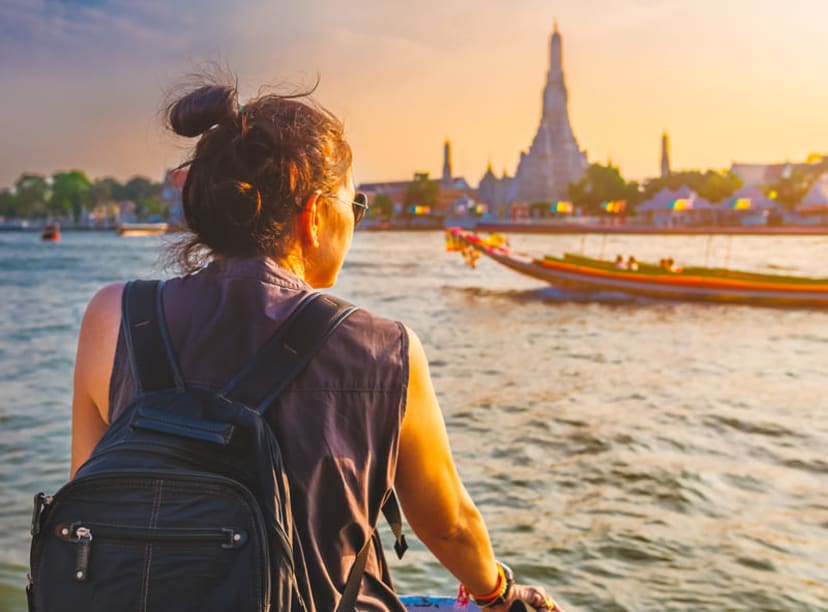 Bangkok river view including Wat Arun and traditional boat