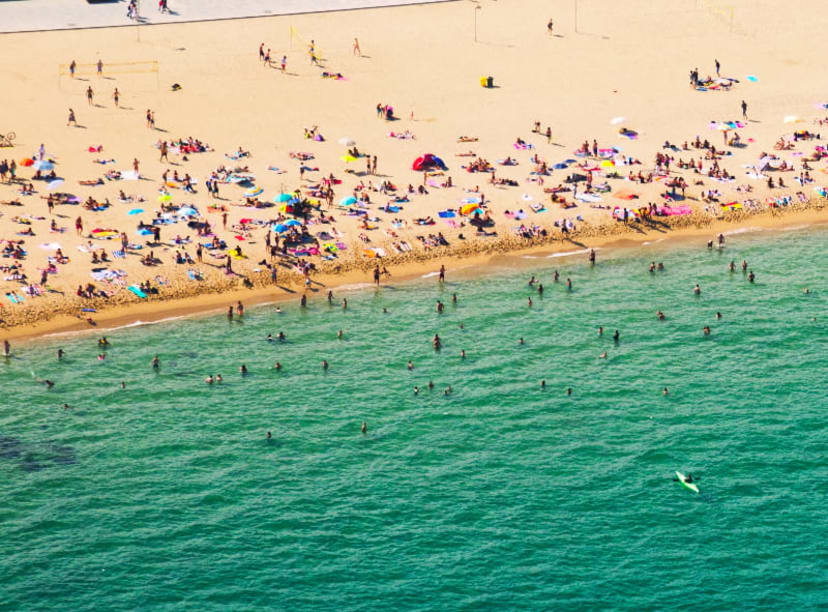 Crowds of tourists on a beach in Barcelona