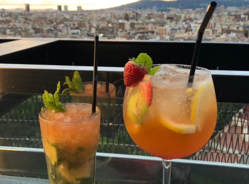 Close up of two delicious cocktails at rooftop bar overlooking Barcelona