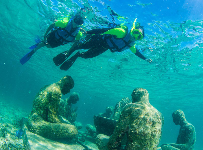 Snorkelers explore the sculptures of Cancun's underwater museum