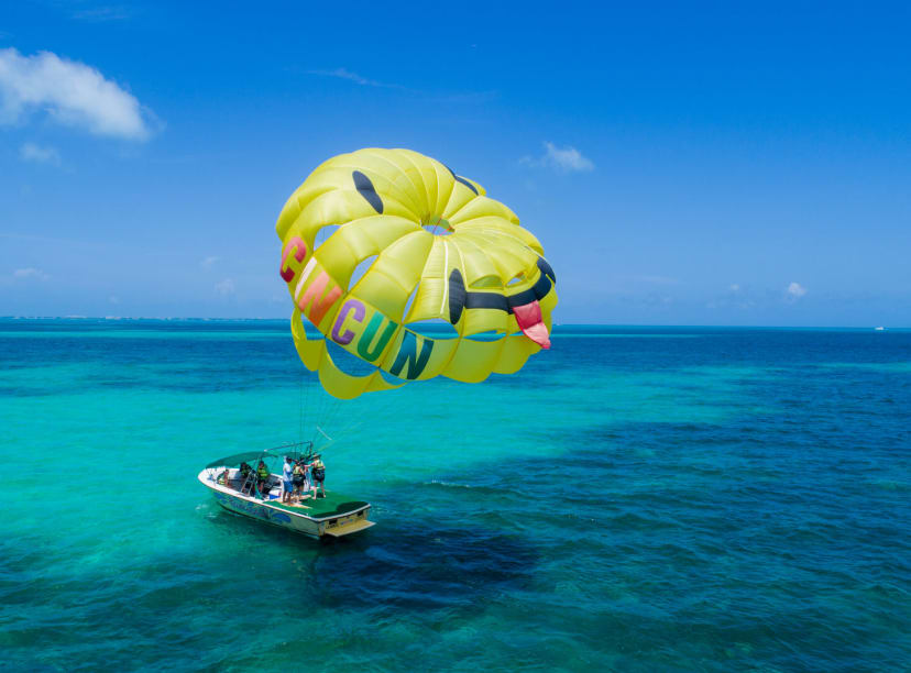 Speedboat with parasail inflated above it in Cancun