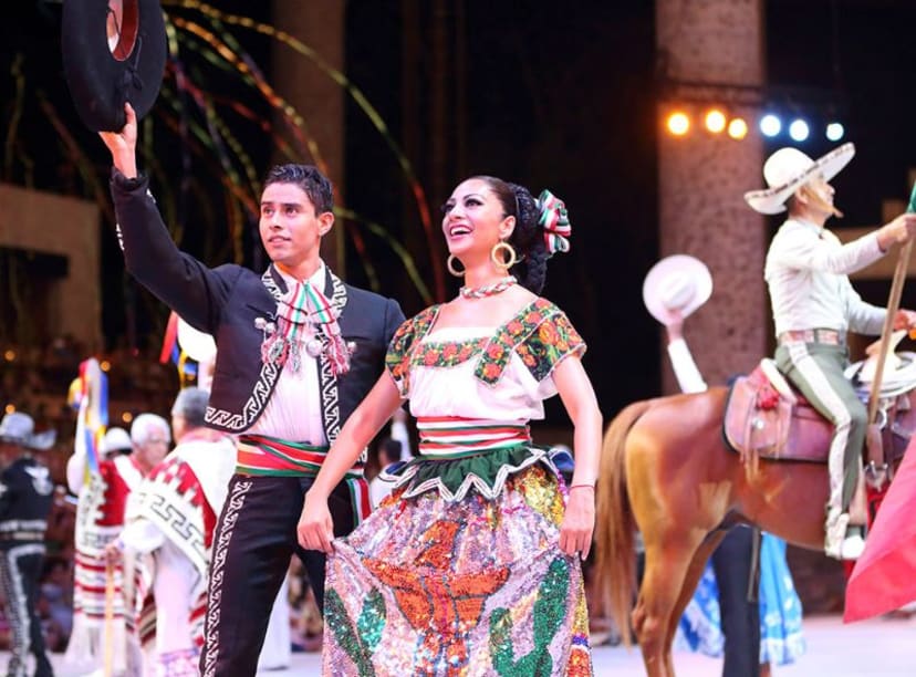 Couple in Mexican traditional dress and cowboy perform at nighttime show at Xcaret park