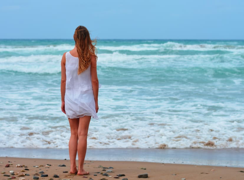 A young woman faces the sea at Cancun in November