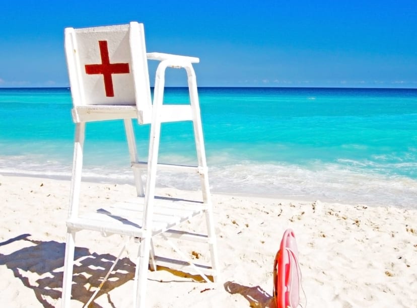 A lifeguard chair stands on shores of a Cancun beach