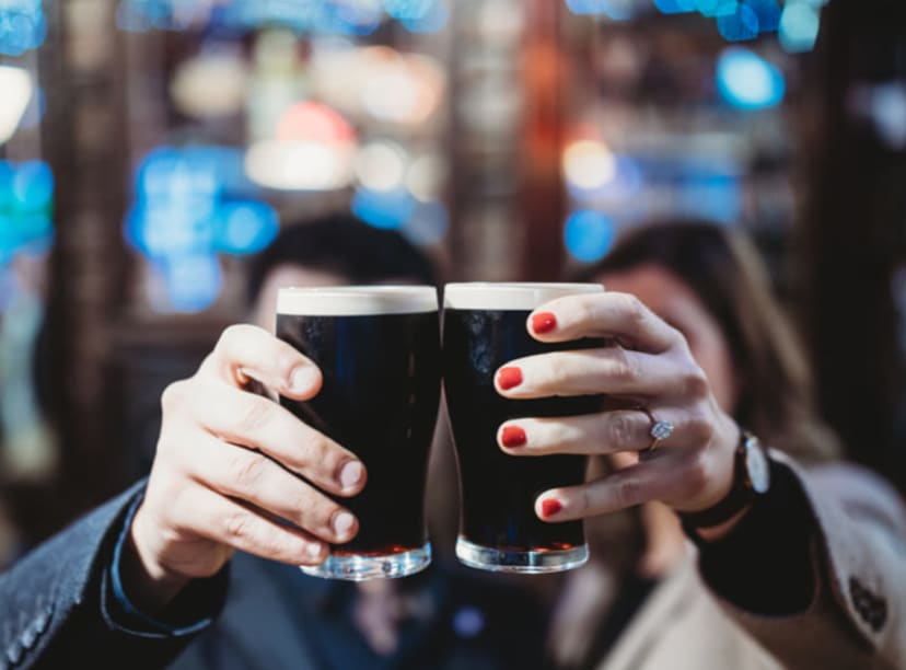 Guinness drinkers toasting in Dublin.