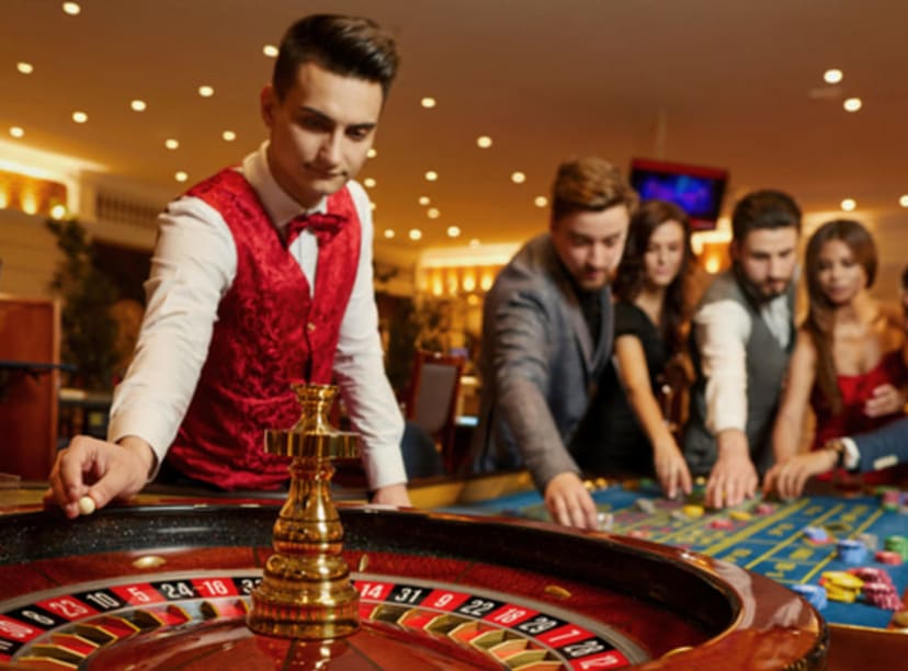 Croupier spinning the roulette wheel in a casino