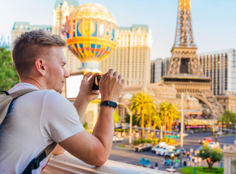 Tourist taking photo of the replica Eiffel Tower in Las Vegas