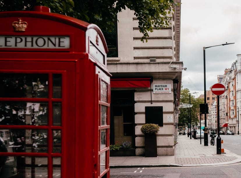 A red telephone box on the corner of Mayfair Place