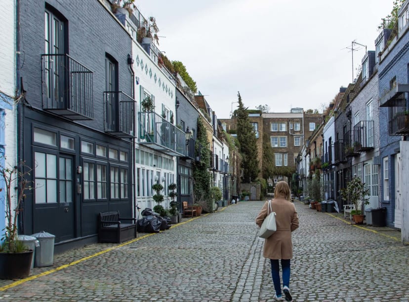 A resident walks down a cobbled Notting Hill side street