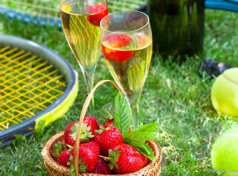 People enjoying a class of champagne at the Wimbledon Championships 