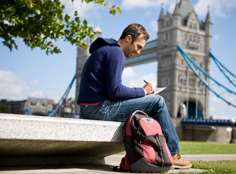 A male tourist considers his options beside Tower Bridge