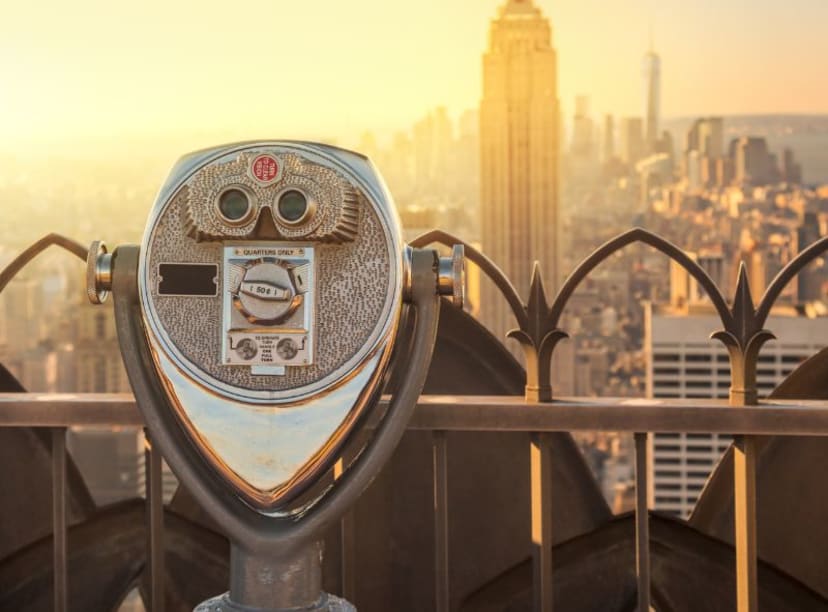 Close up of viewing station at TOTR with Empire state building glowing gold in distance