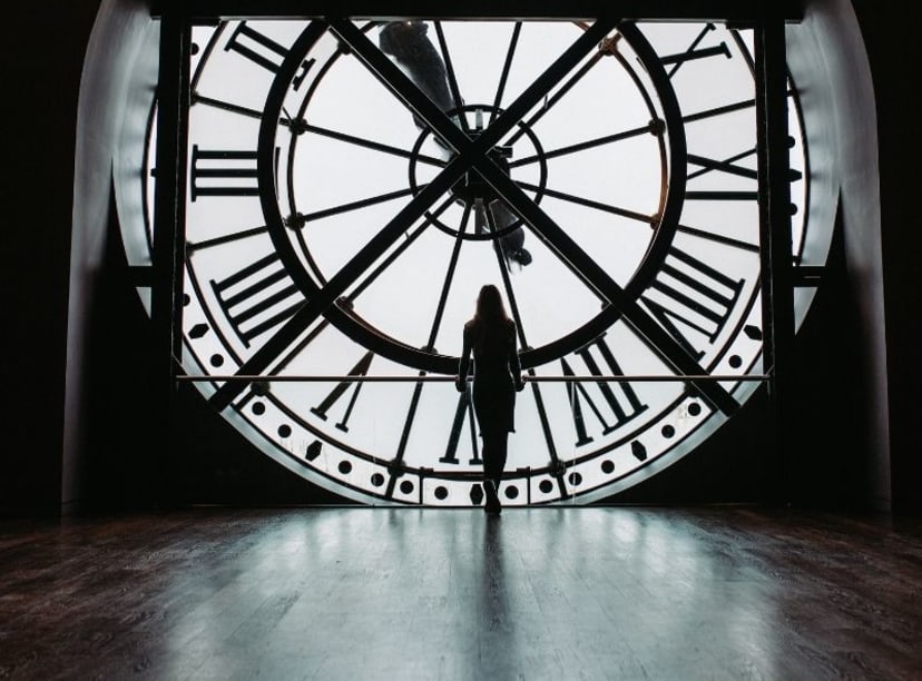 Tourist behind the station clock at Musée d'Orsay in Paris.