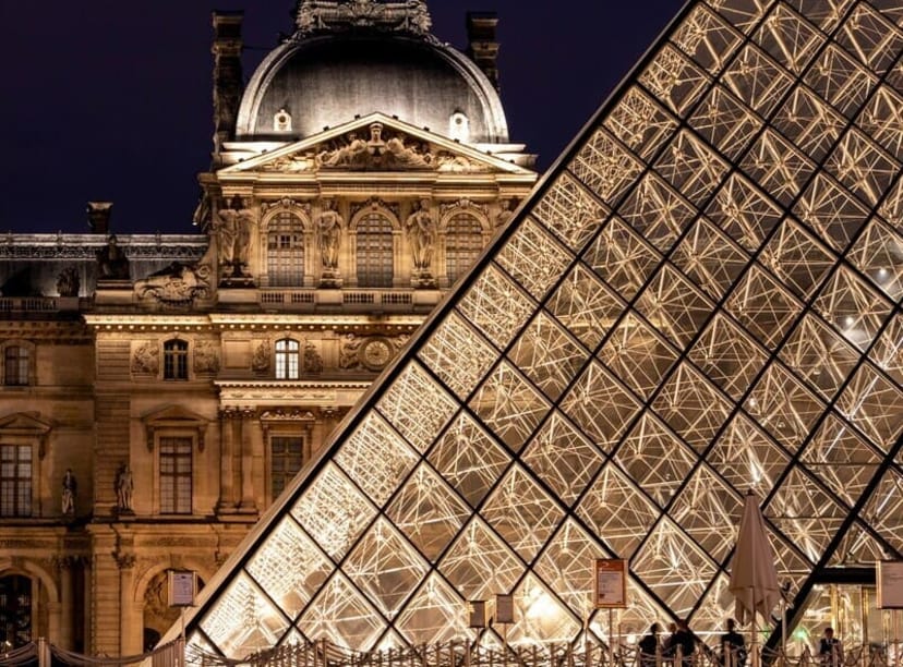 The Louvre Museum and pyramid at night