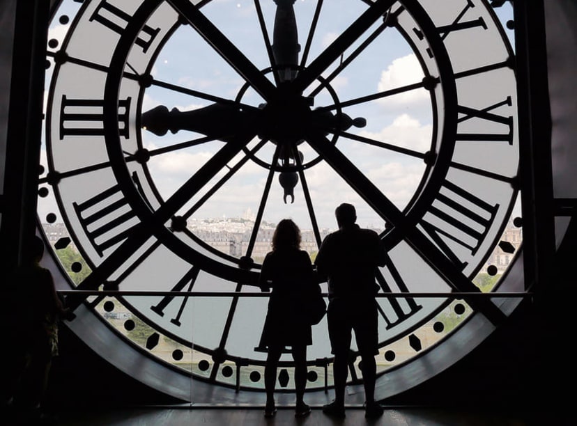 Couple looking through the fifth-floor clock window at Musée d'Orsay