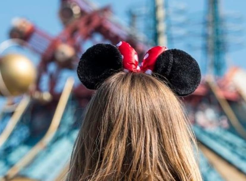 Young girl walks towards an attraction at Disneyland Paris