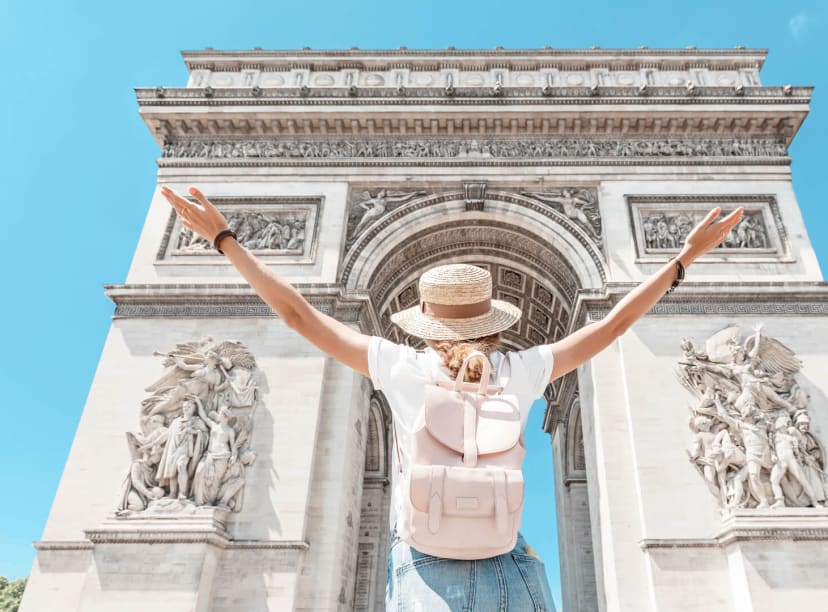 A tourist admires the Arc du Triomphe