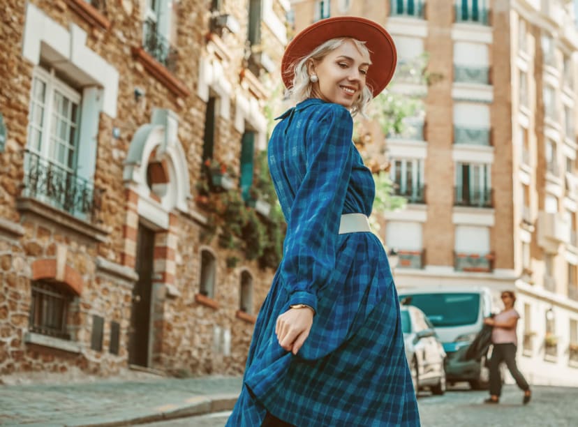 A woman shows off her latest clothing finds on the streets of Paris