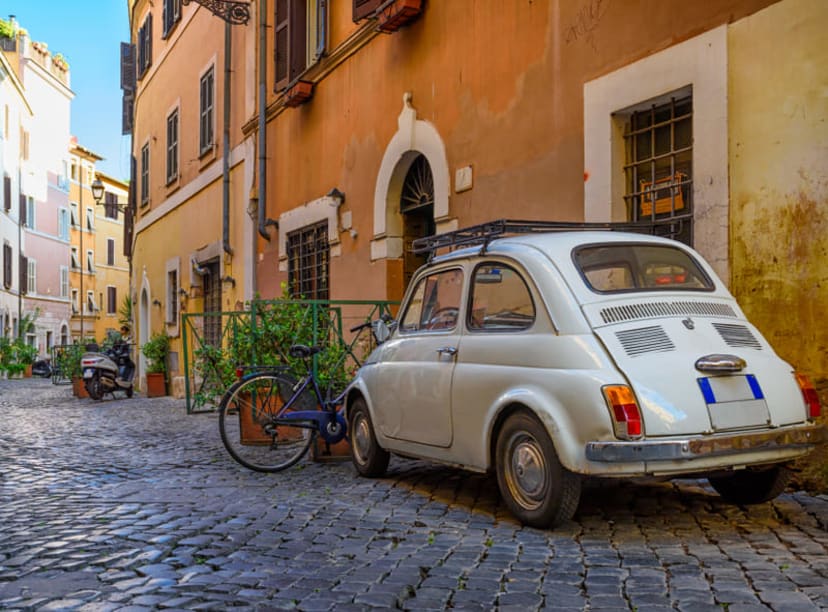 A cobbled street full of typical ocher-colored houses in Trastevere, Rome