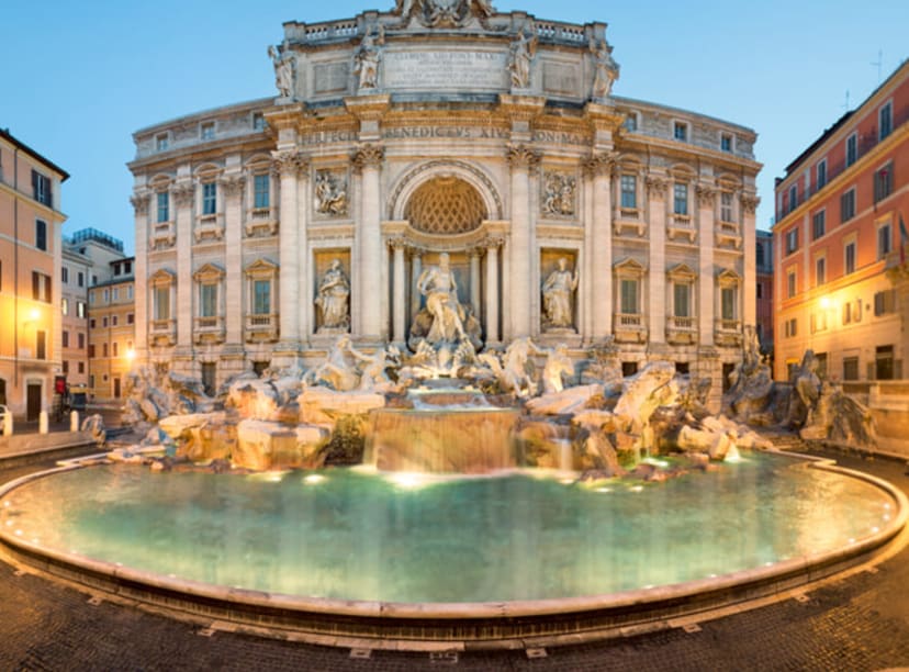 The Trevi Fountain in Rome, illuminated at dusk