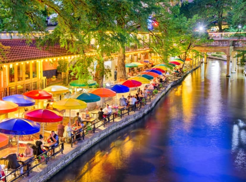 Brightly colored parasols lining the River Walk at sundown.