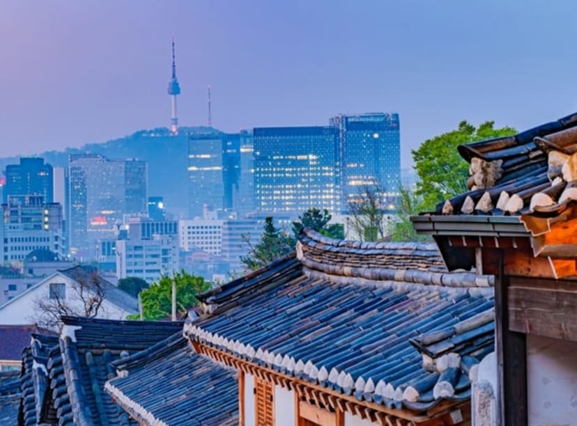 N Seoul Tower glimpsed across the city's rooftops at dusk.