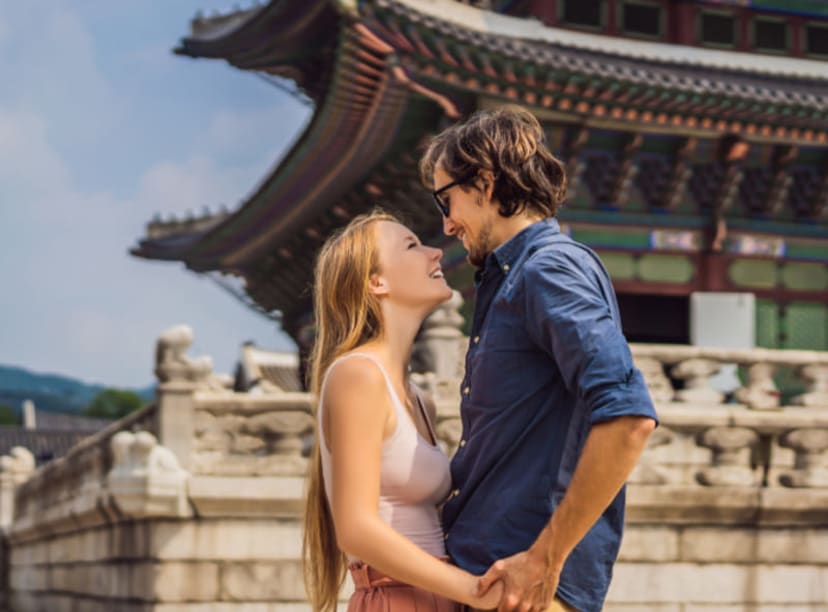 Young couple visiting a palace in Seoul.