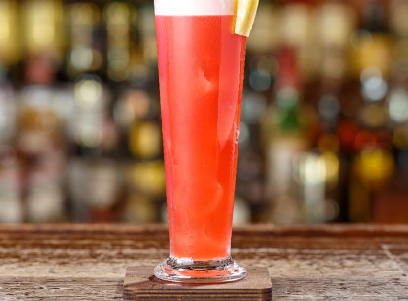 Singapore sling sitting on a bar