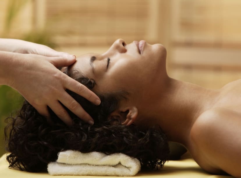 Lady getting a head massage at a luxury spa