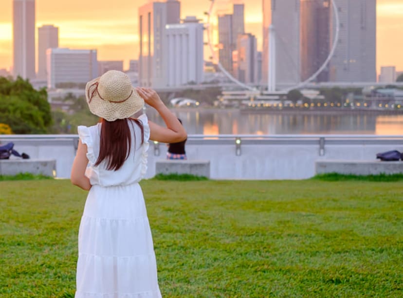 Woman looking across the water to the Singapore Flyer