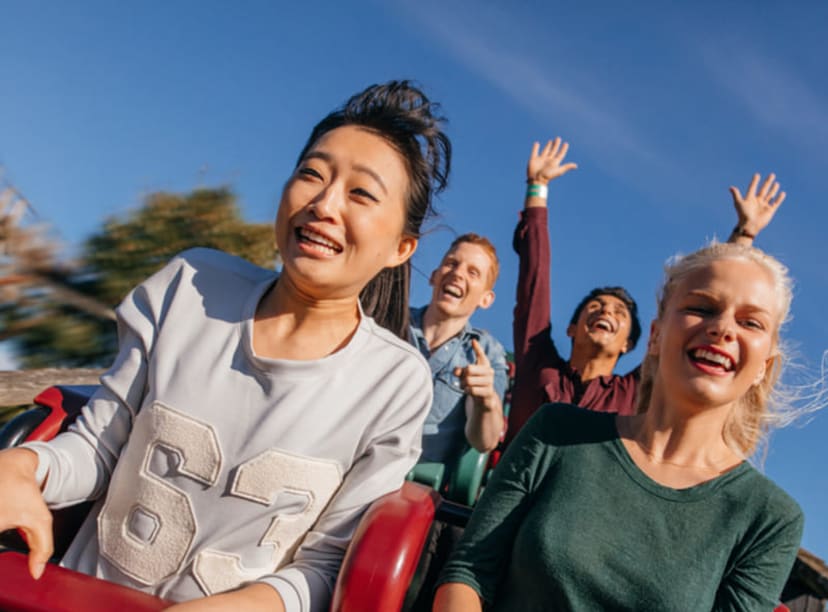 Friends having fun on a rollercoaster.