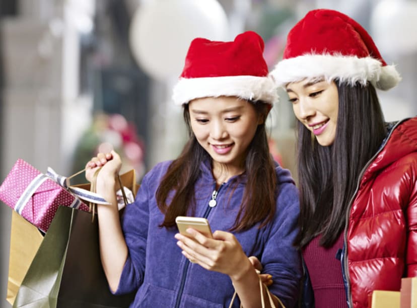 Women out shopping in Christmas hats