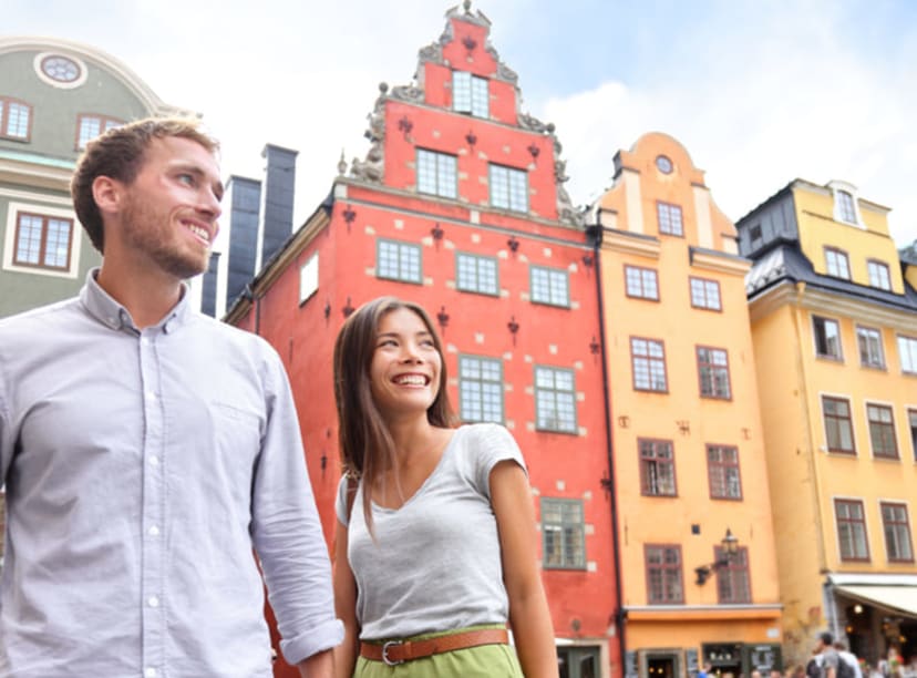 Young couple exploring Gamla Stan, Stockholm's colorful old town.