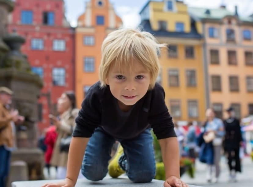 Little boy exploring Stortorget square in Stockholm's old town