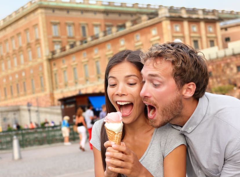 Couple eating ice cream in front of the Royal Palace in Stockholm