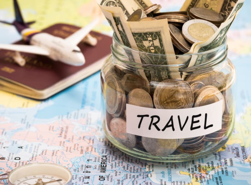Map, passport, toy plane and jar full of travel money