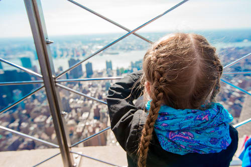 Girl looks out at NYC skyline