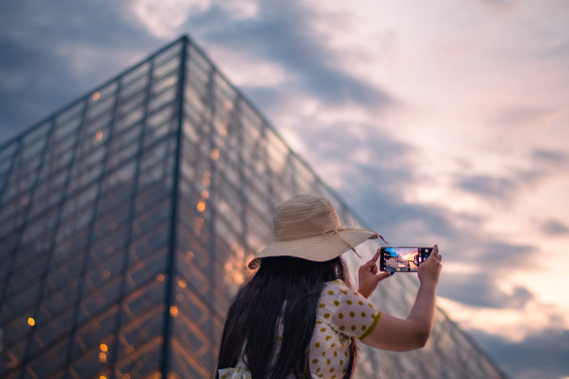 Woman photographing the Louvre