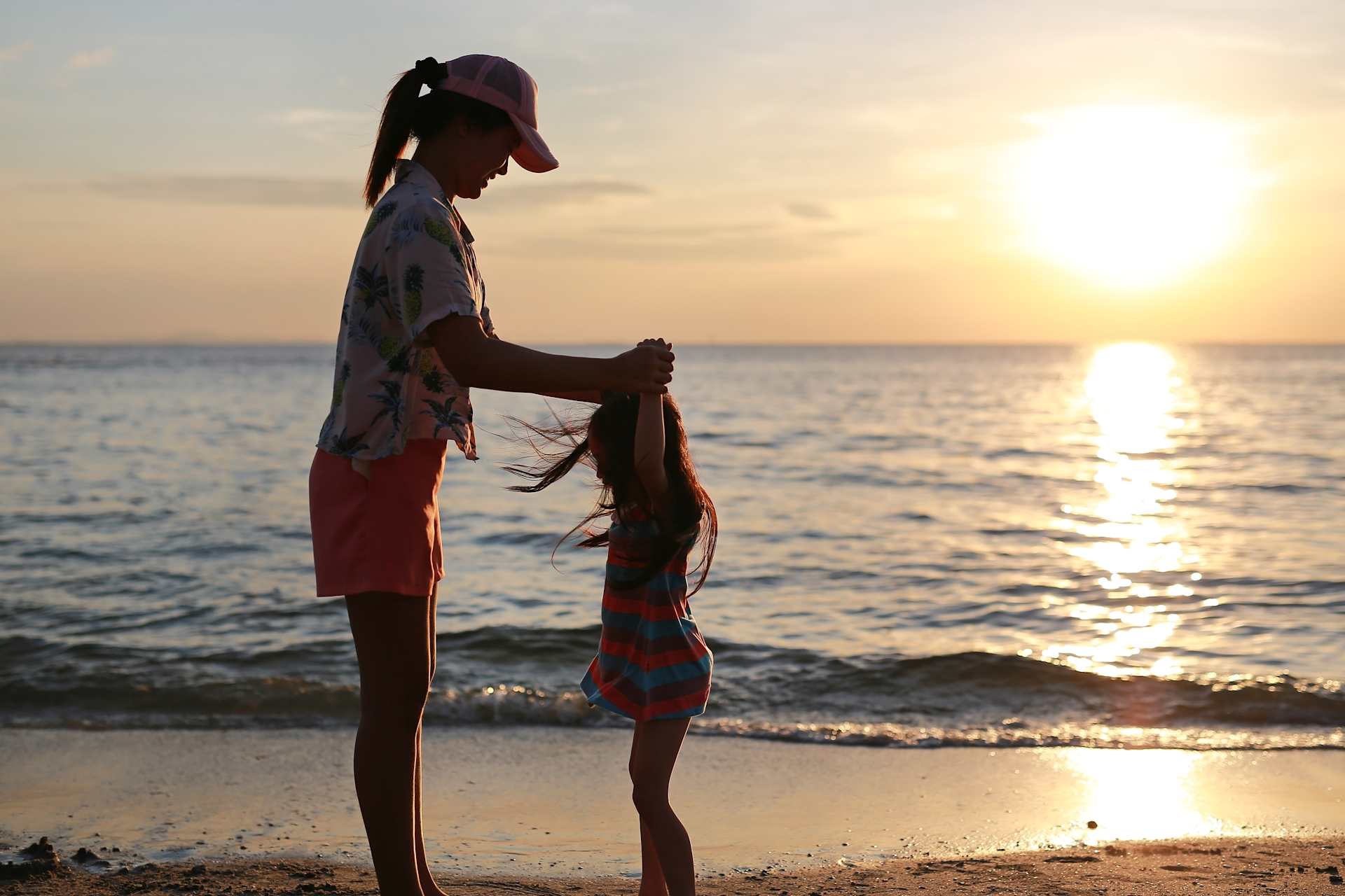Mother and Daughter on the Beach at Sunset