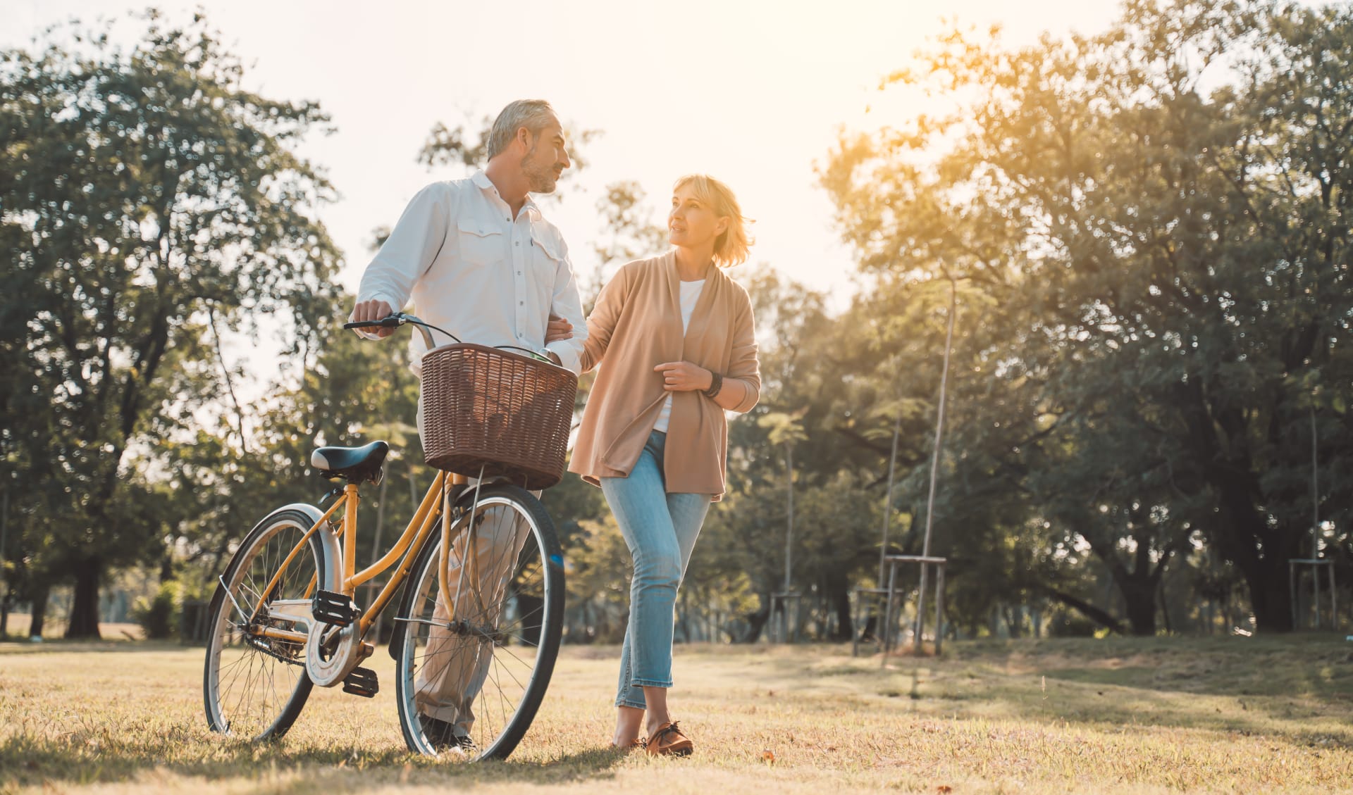 beautiful-senior-couple-walking-their-bike