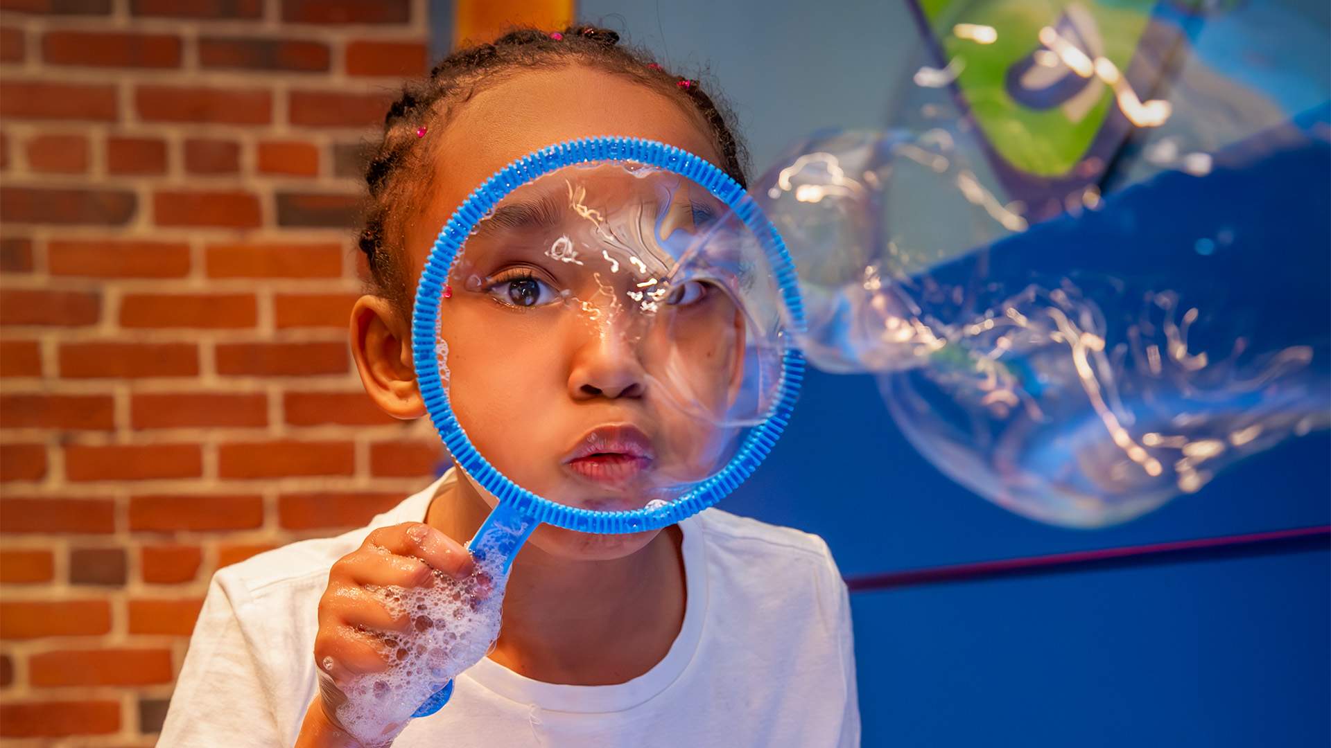 Child Blowing Bubbles at Boston Children's Museum