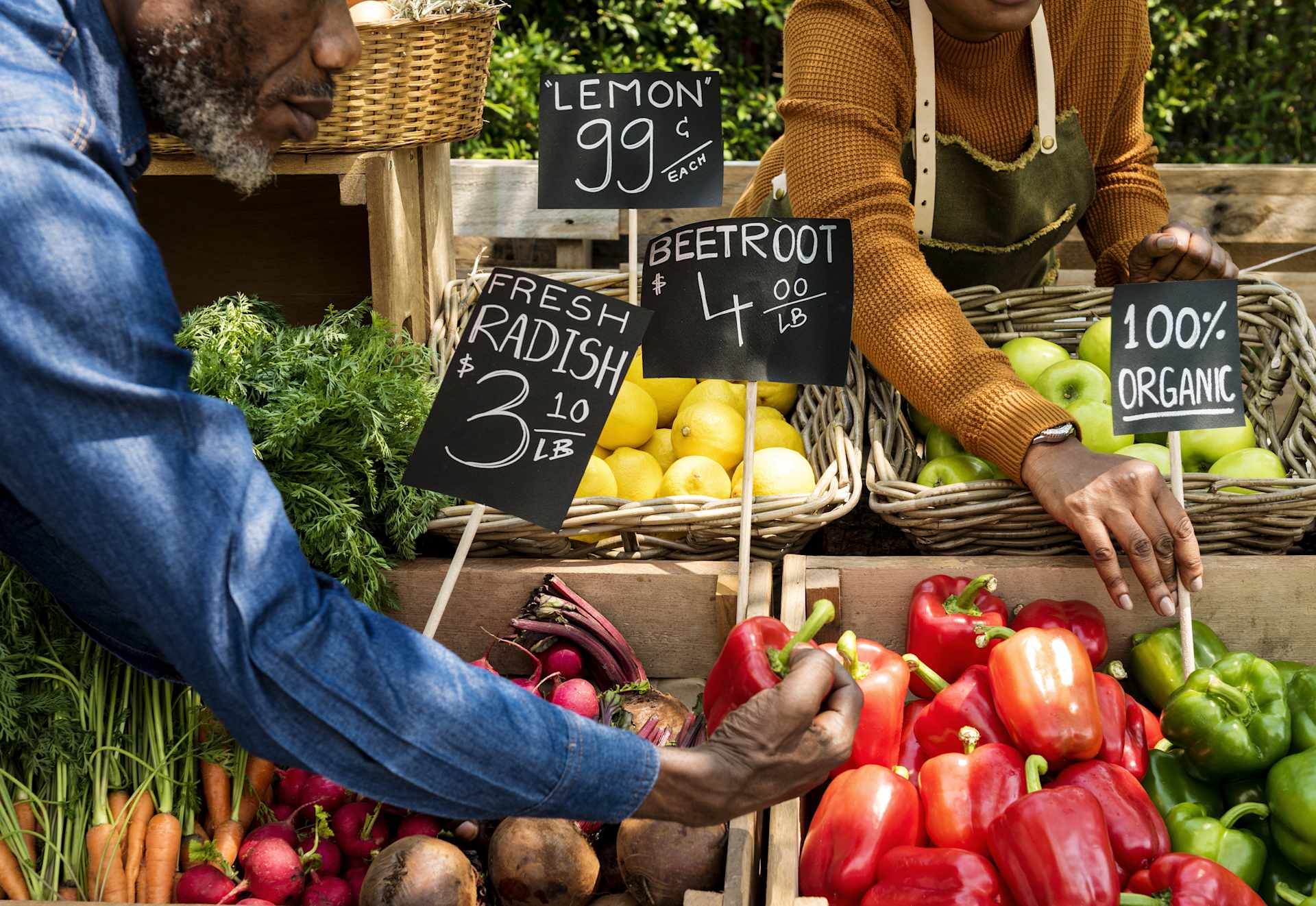 Man Picking Vegetables at a Food Market