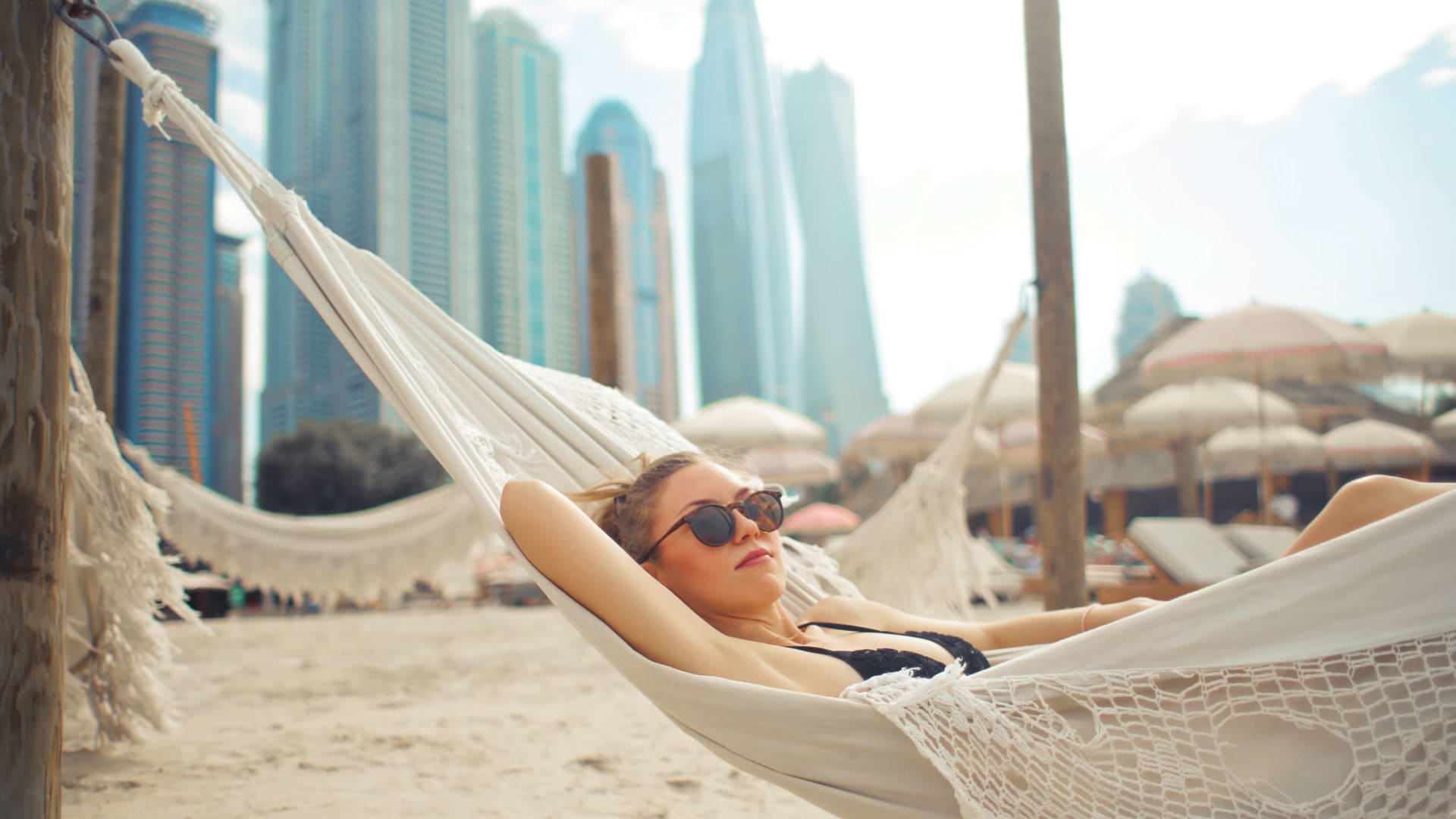 Woman relaxing in a beach hammock