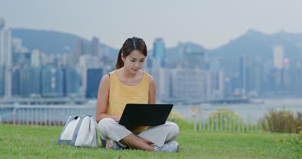 Woman working on her laptop in a Hong Kong park