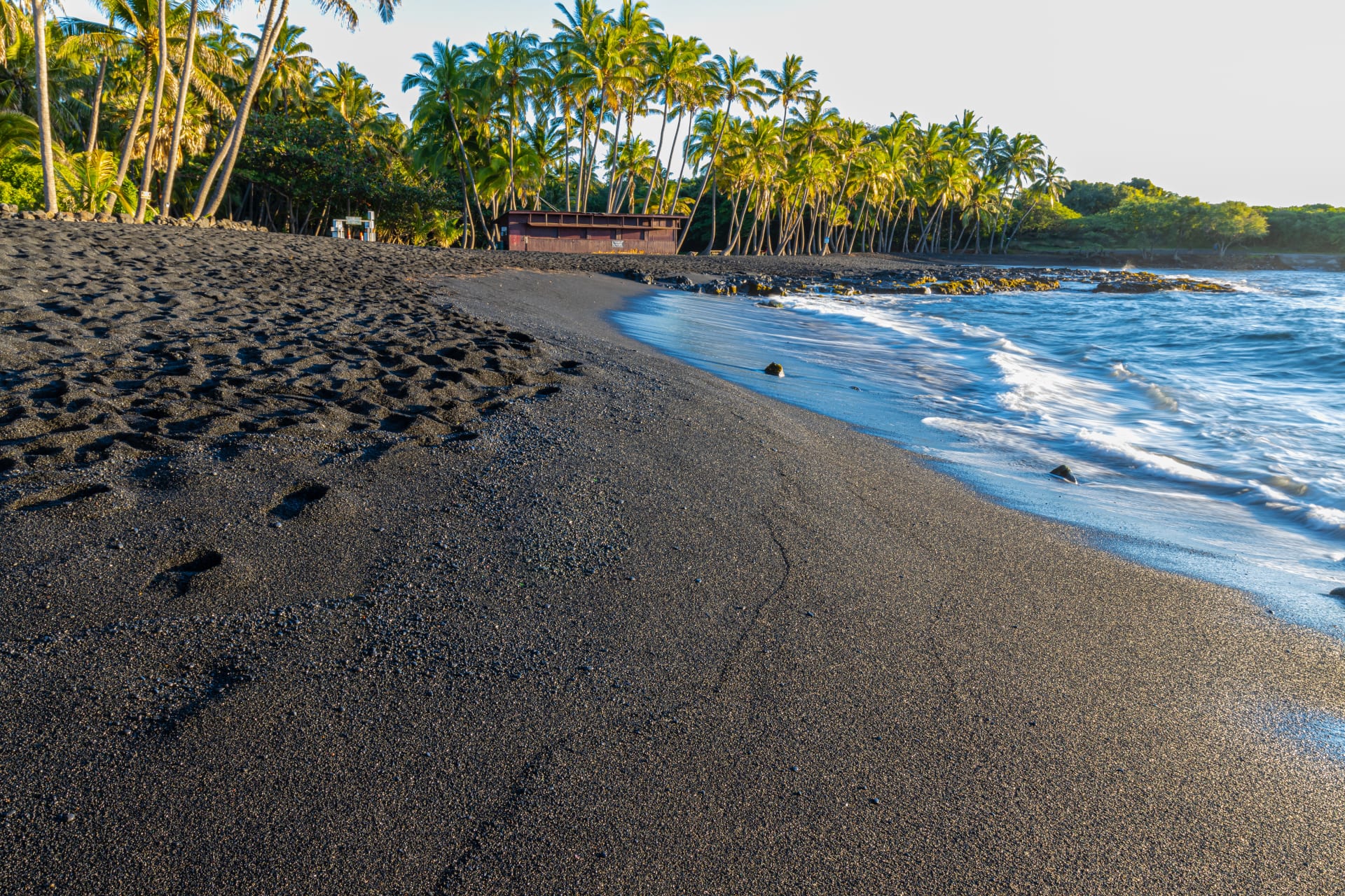 The black volcanic sands of Punaluu Beach in Hawaii