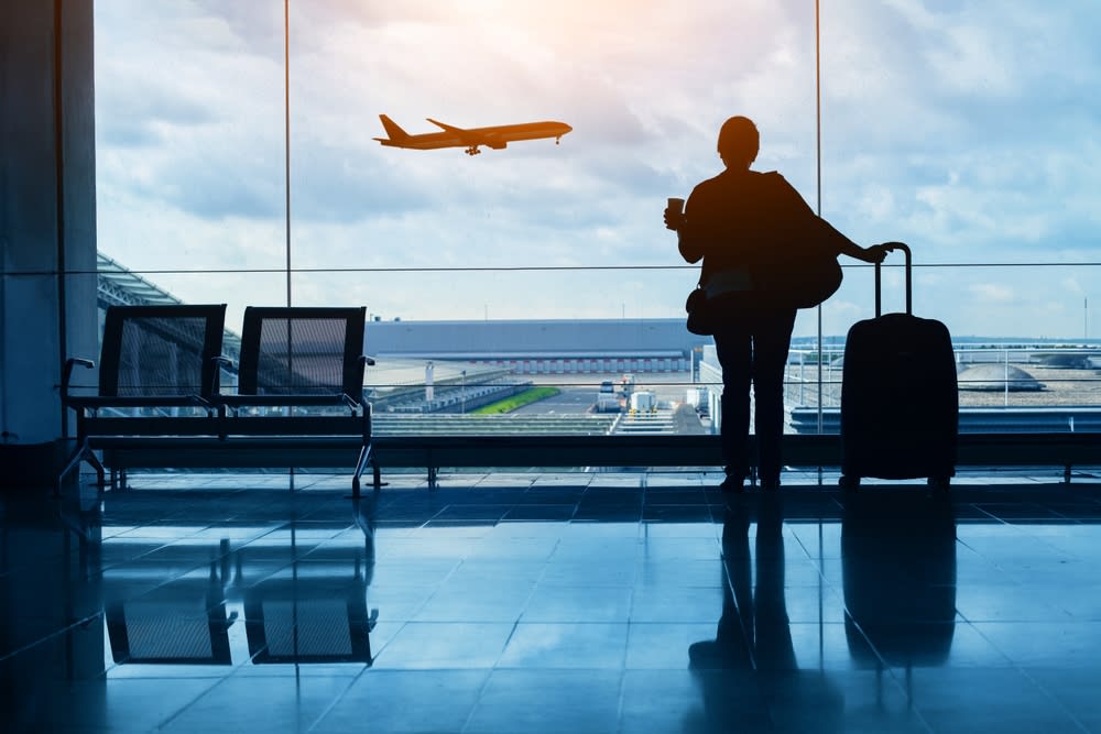 Passenger watching a plane taking off at the airport