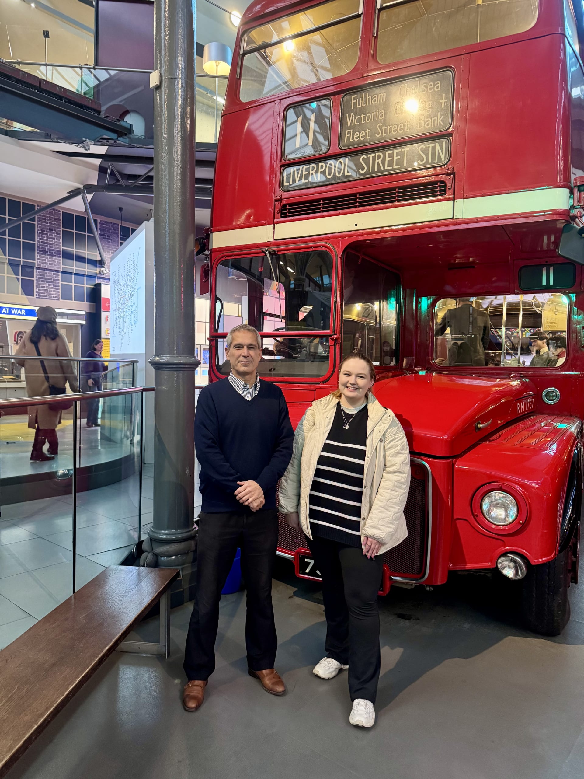 2 people in front of a route master bus at London Transport Museum