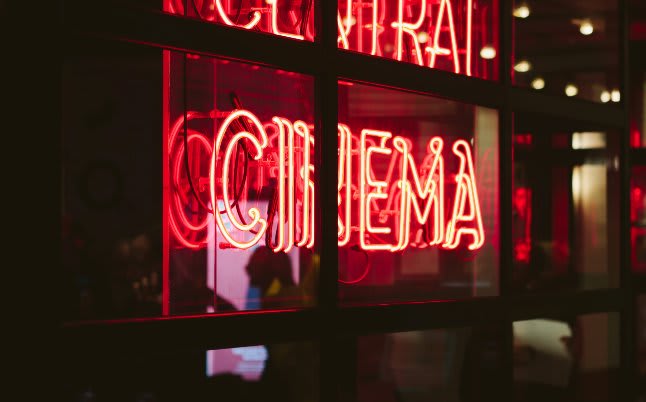 fluorescent Curzon Cinema sign outside the theatre at night