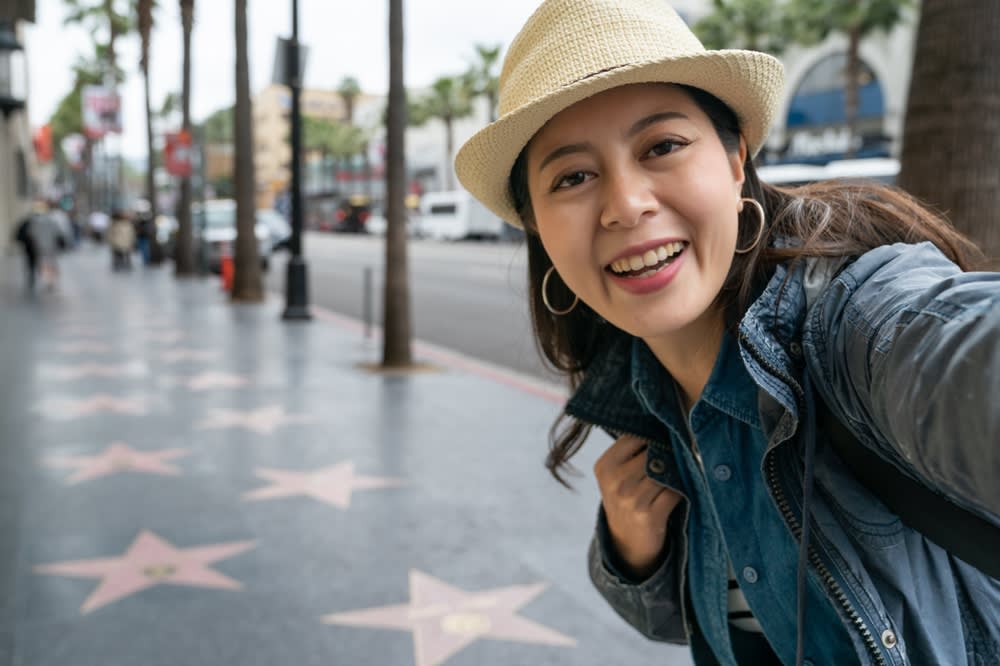 Woman taking selfies on the Hollywood Walk of Fame